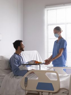 male-patient-bed-talking-nurse